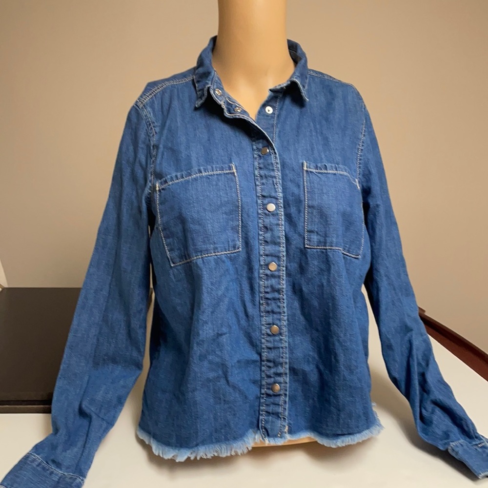 Denim shirt w/ fringe at the bottom.